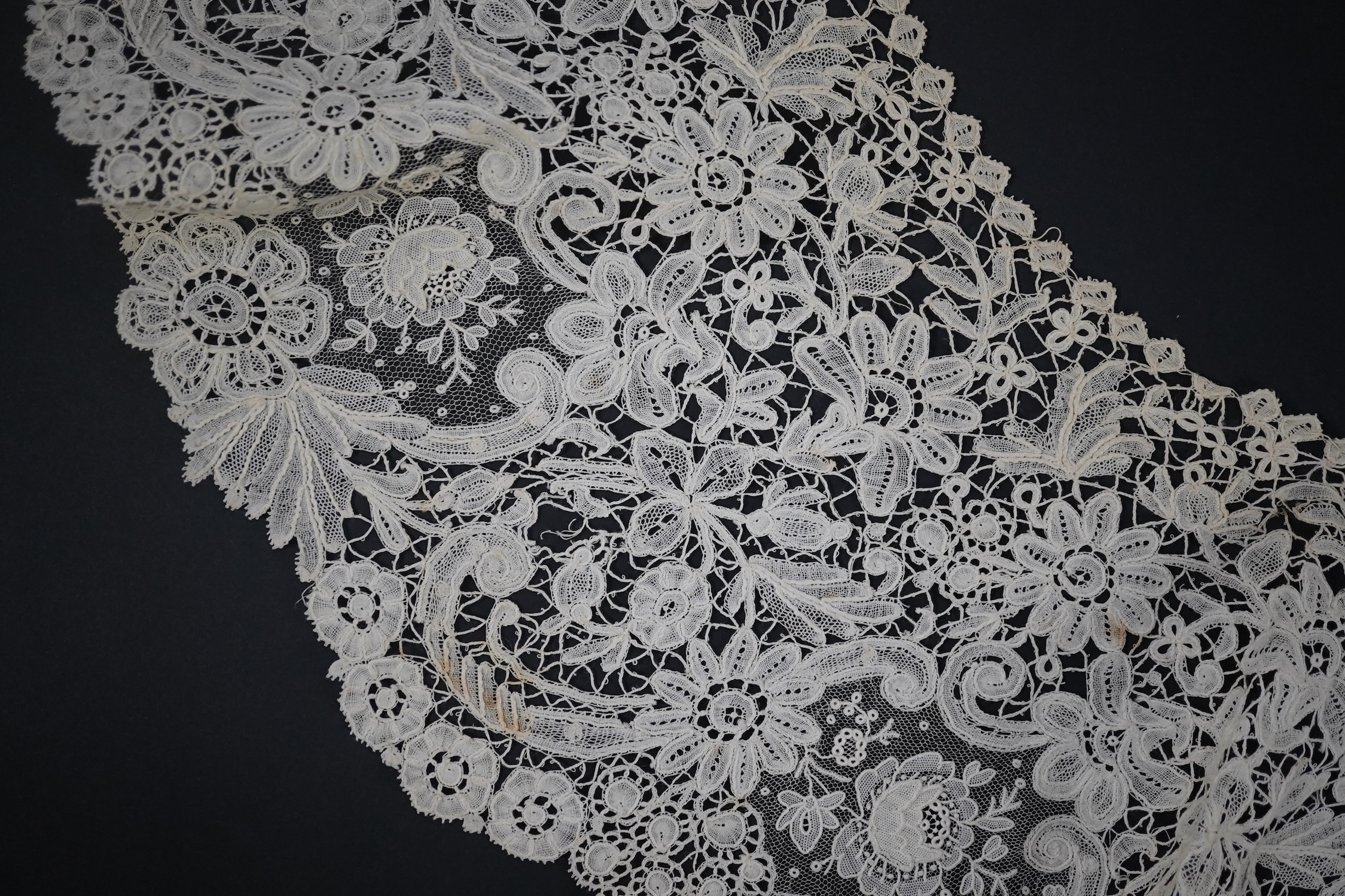 An 1860’s unused, large circular flounce shaped collar of mixed Brussels bobbin lace, with twelve needle lace Point de Gaz insertions, 18.5cm deep, approximately 248cm along bottom, edge. Condition - good